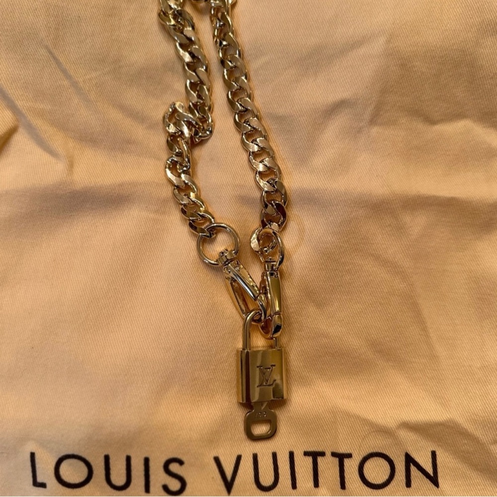 Louis Vuitton Authentic key and lock with brass chain.